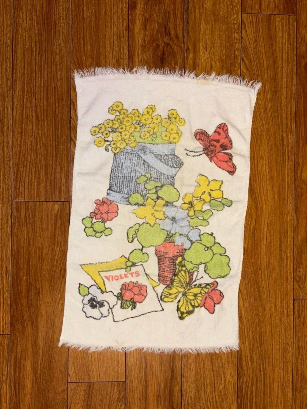 Vintage 1970s hand towel with a floral design and butterflies